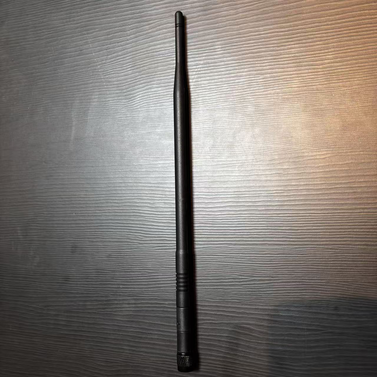 GLR915 900MHz rubber antenna product photo, studio lighting, white background, centered, realistic black rubber materials, cylindrical shape Ø14×395mm, RP-TNC male connector, clean shadow, high detail, no text, no watermark